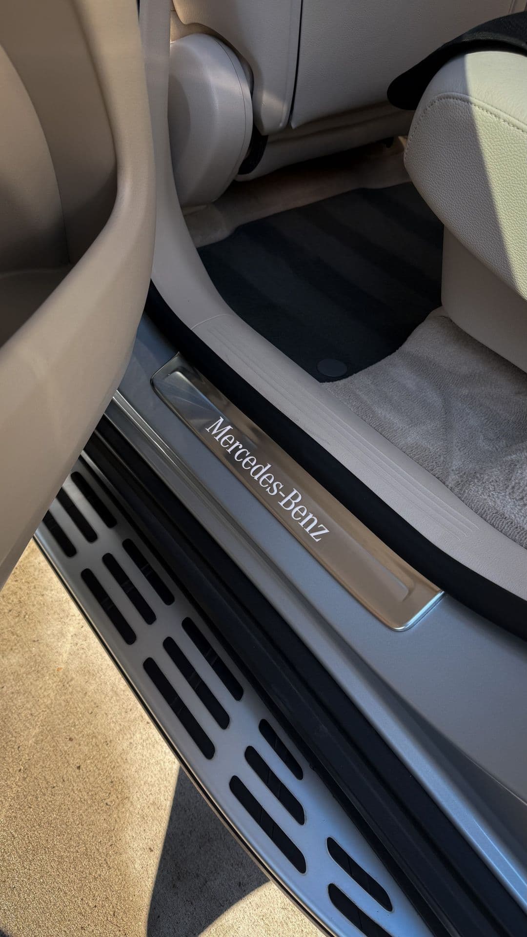 A close-up of a cleaned door sill and seat base after an interior detail
