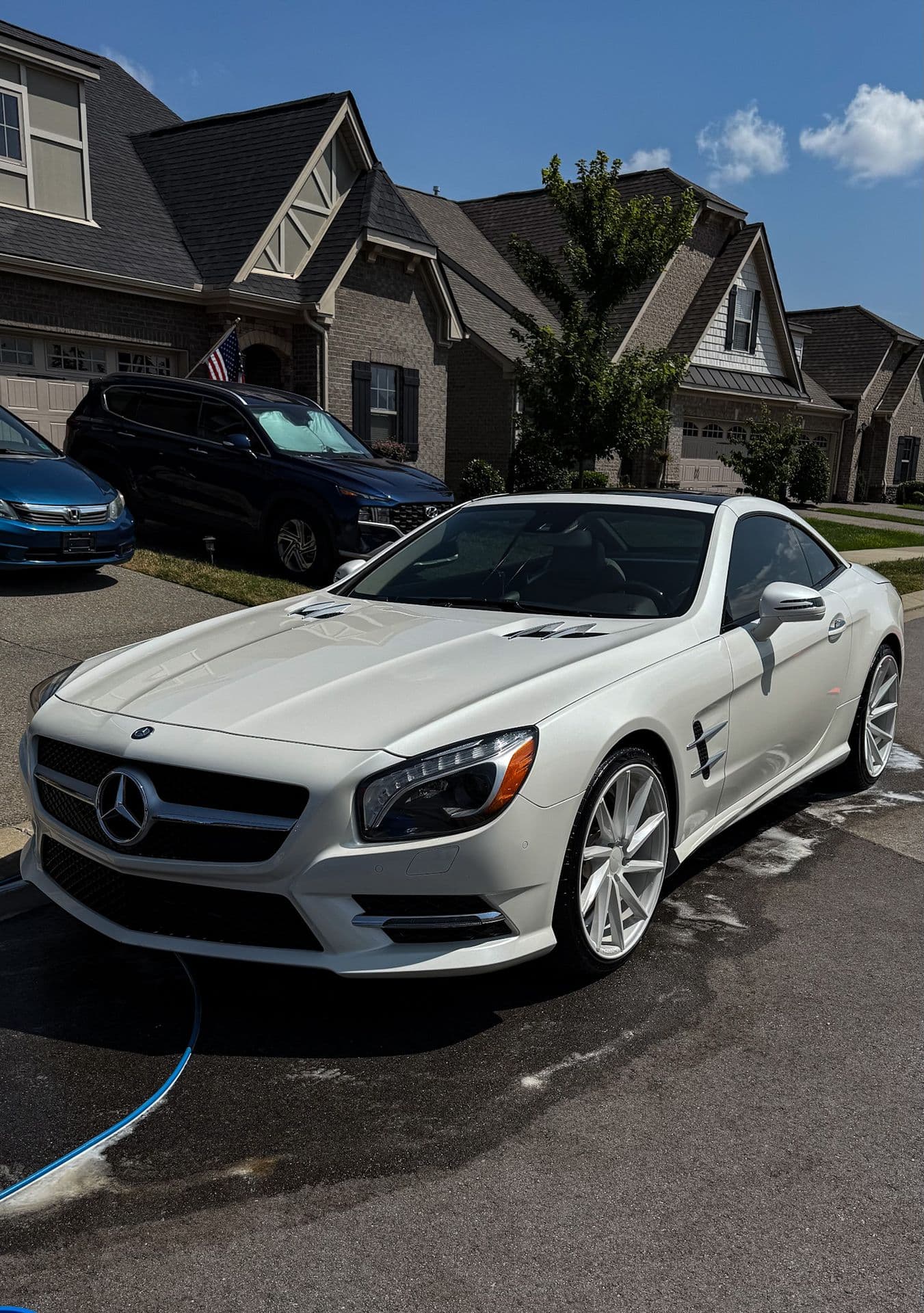 An Eagle Pressure hand wash underway on a customer’s convertible in their driveway