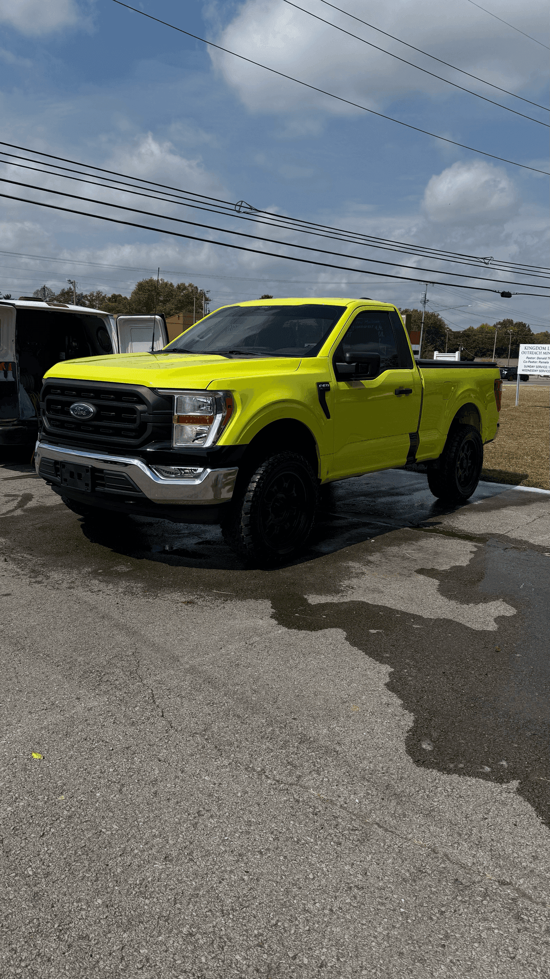 A yellow pickup truck finished after an exterior detail